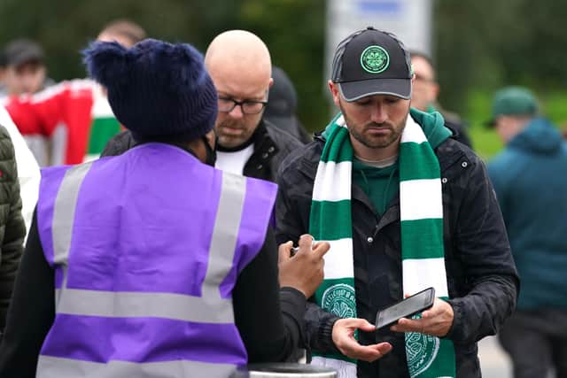 Celtic fans queue to show their vaccine passports as they enter the ground for the UEFA Europa League Group G match at Celtic Park, Glasgow.