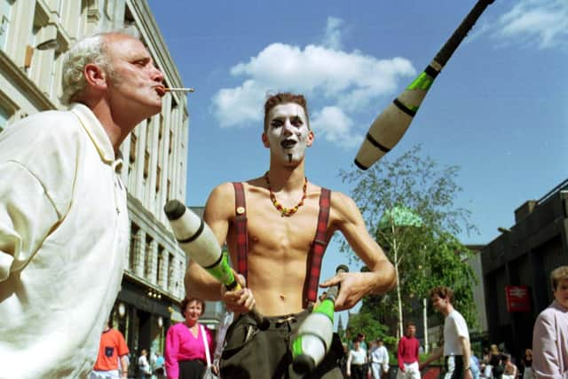 A street entertainer juggling in Argyle Street on a sunny Glasgow day in June 1992.