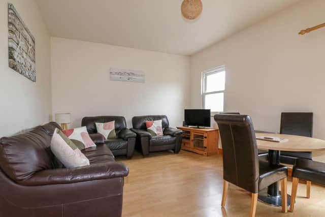 The open-plan living area at 13 Palm View, Newquay. Available to book through Sykes Cottages.