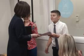 Danial Mutch receives his award from Clydesdale MSP Mairi McAllan.