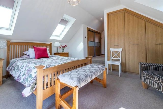 The spacious master bedroom has an en suite and big wardrobes.