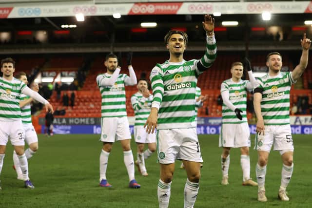 Celtic's Jota celebrates at full time in front of the away fans.