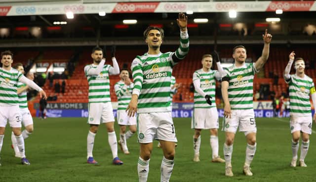 Celtic's Jota celebrates at full time in front of the away fans.