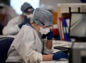 Under pressure: A member of staff at University Hospital Monklands makes a telephone call on the ICU ward.. Photo by Jeff J Mitchell/Getty Images