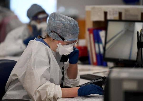 Under pressure: A member of staff at University Hospital Monklands makes a telephone call on the ICU ward.. Photo by Jeff J Mitchell/Getty Images