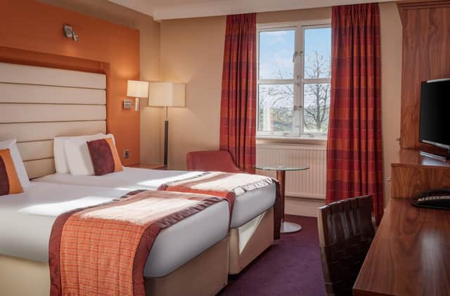 A twin room with comfortable twin beds and an en-suite bathroom. Image: Pellier Photography
