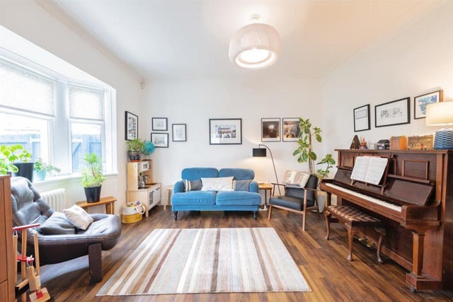 The spacious living room has a beautiful bay window.