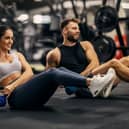 People working out lifting weights in a gym.