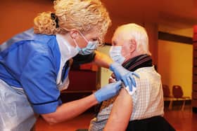 18-01-2021. Picture Michael Gillen. FALKIRK. Day 298 of UK wide coronavirus lockdown measures. Day 14 of mainland Scotland Lockdown Two. Falkirk is in Level 4. FALKIRK. Falkirk Town Hall. NHS Forth Valley, Community covid vaccination clinic starts today. Pfizer-BioNTech Covid-19 vaccine being used today. Tracey McGregor, immunisation staff nurse and John Shepherd 82 from Camelon.