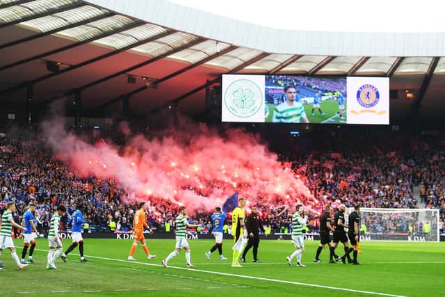 Celtic and Rangers come on to the pitch at Hampden.