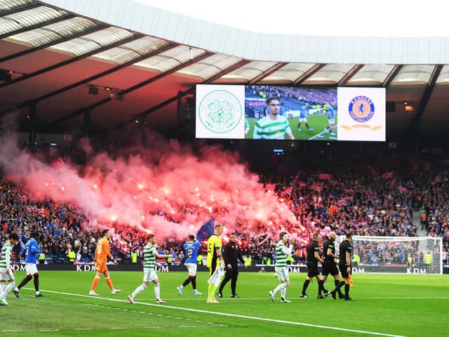 Celtic and Rangers come on to the pitch at Hampden.