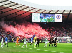 Celtic and Rangers come on to the pitch at Hampden.