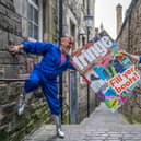 Cris Peploe and Martha Haskins pose with a large-scale version of the Edinburgh Festival Fringe 2023 programme cover in Anchor Close in the city's Old Town. Picture: Jane Barlow/PA Wire