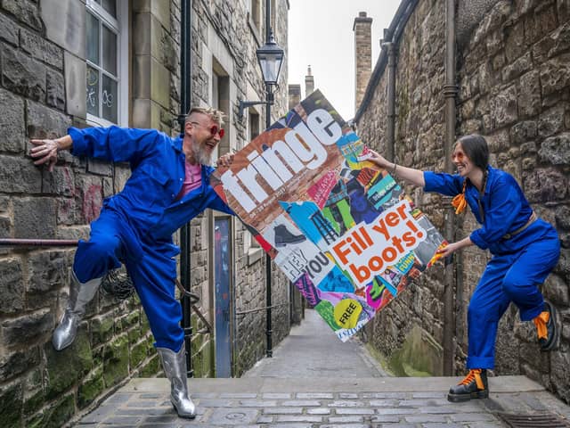 Cris Peploe and Martha Haskins pose with a large-scale version of the Edinburgh Festival Fringe 2023 programme cover in Anchor Close in the city's Old Town. Picture: Jane Barlow/PA Wire