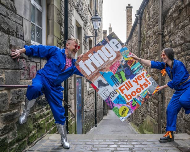Cris Peploe and Martha Haskins pose with a large-scale version of the Edinburgh Festival Fringe 2023 programme cover in Anchor Close in the city's Old Town. Picture: Jane Barlow/PA Wire