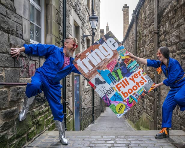 Cris Peploe and Martha Haskins pose with a large-scale version of the Edinburgh Festival Fringe 2023 programme cover in Anchor Close in the city's Old Town. Picture: Jane Barlow/PA Wire