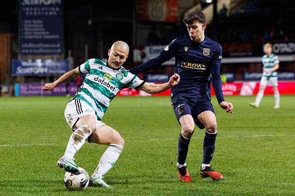 Daizen Maeda (left) of Celtic in action against Owen Beck of Dundee