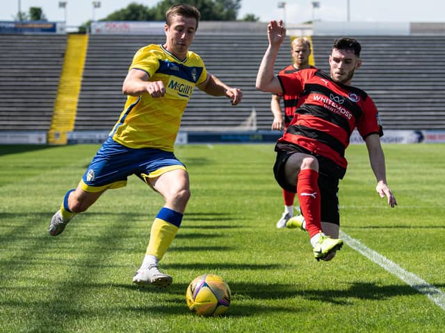 Clyde’s Adam Livingstone tries to prevent Morton’s Darren Hynes getting the ball into the danger area (pic: GBR Photos)