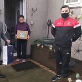 Clyde manager Danny Lennon and Community Foundation manager Tom Elliott make a delivery to Margaret McLaren