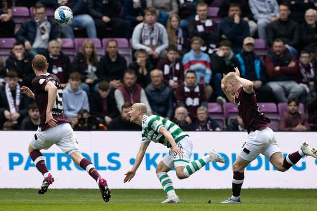 Alex Cochrane, right, is judged to have fouled Daizen Maeda, leading to a red card for the Hearts player. Picture: SNS