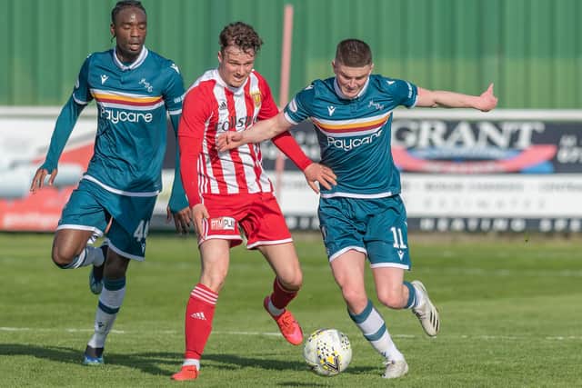 Formartine's Aaron Norris battles for the ball with Motherwell's Devante Cole and Jake Hastie on Saturday (Photo by Dave Cowe)