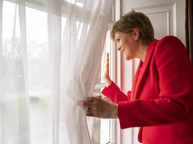 First Minister Nicola Sturgeon waves to people gathered outside Bute House in Edinburgh, after announcing that she will stand down as First Minister of Scotland. (Photo credit: Jane Barlow/PA)