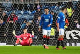 Rangers goalkeeper Jack Butland sits dejected after conceding the opening goal scored by Dundee United's Sam Dalby on Saturday
