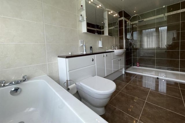 The master en-suite boasts a large shower enclosure as well as a bath to soak away those aches and pains.