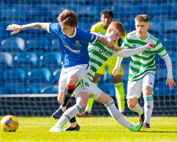 Rangers Alex Lowry tackles Celtic's Ben Summers during a Lowland League match between Rangers B and Celtic B.