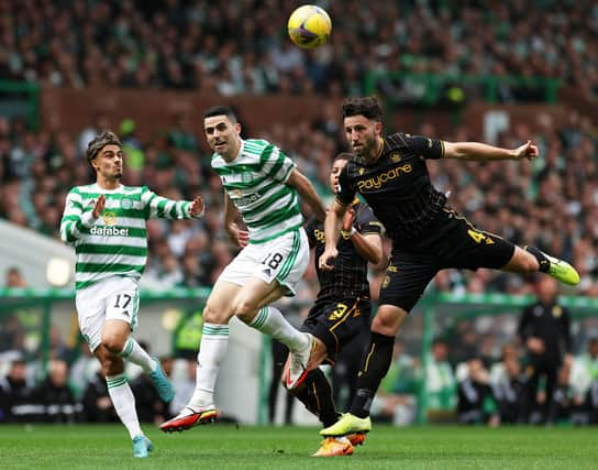 Ricki Lamie battles for the ball with Tom Rogic