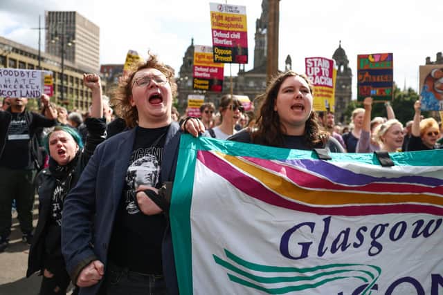 Protesters hold banners during a "Stop the Far Right" demonstration at George Square Glasgow