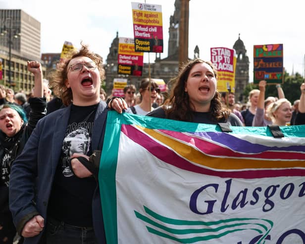 Protesters hold banners during a "Stop the Far Right" demonstration at George Square Glasgow