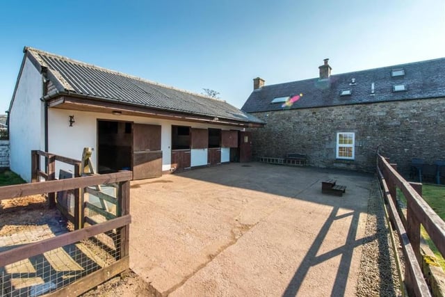 A mix of concrete block and traditional stone with a concrete floor, there are three stables and a tack/feed room.