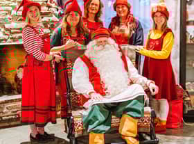 Santa Claus and his helpers ready to receive letters from around the world