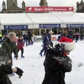 The final Saturday before Christmas in 2000. These  two sisters enjoy a snowball fight on the Ice -rink in George Square.