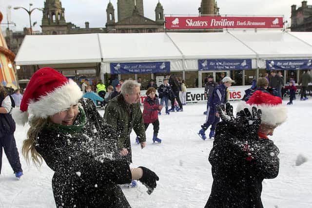 The final Saturday before Christmas in 2000. These two sisters enjoy a snowball fight on the Ice-rink in George Square.