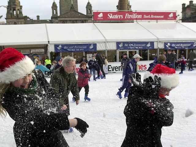 The final Saturday before Christmas in 2000. These  two sisters enjoy a snowball fight on the Ice -rink in George Square.