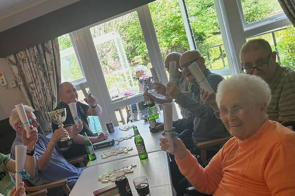 Residents at HC-One Scotland’s Eastbank Care Home participating in dominoes tournament during Care Home Open Week 2025