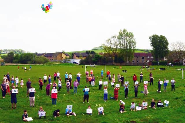 Waterside residents send a clear message to the council on the very green space they face losing. Pic: Edward Z Smith