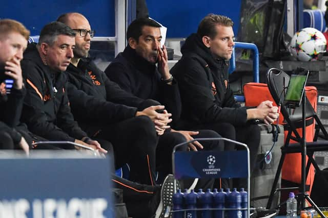 Giovanni van Bronckhorst cuts a dejected figure in the Rangers dugout.