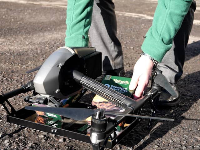 Loading up the Holland's pies on the drone for delivery (photo: Ben Frith)