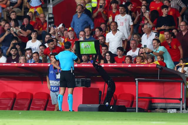 Referee Serdar Gozubuyuk checks the VAR monitor before disallowing the goal scored by Scott McTominay. (Photo by Fran Santiago/Getty Images)