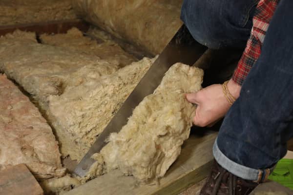 File photo dated 14/11/17 of a person laying loft insulation. Barclays has extended its scheme to pay up to £2,000 to mortgage holders to help make their homes green as new research shows more than half of homeowners do not feel confident making their properties more energy efficient. Issue date: Thursday July 6, 2023.