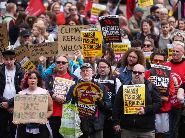 Protesters hold banners during a "Stop the Far Right" demonstration at George Square in Glasgow, Scotland.