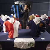 McTear's auctioneers James Bruce and Amy Cameron with the Bertie Auld collection. Ms Cameron is holding the jersey of Inter captain Armando Picchi. Picture: McTear's