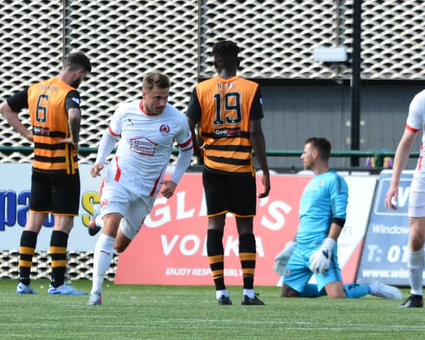 David Goodwillie runs off in celebration after grabbing the winner for Clyde against Alloa (pic: David Glencross)