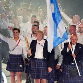 Alex Marshall, flag bearer of Scotland alongside Sarah Adlington, baton bearer leads their delegation during the opening ceremony