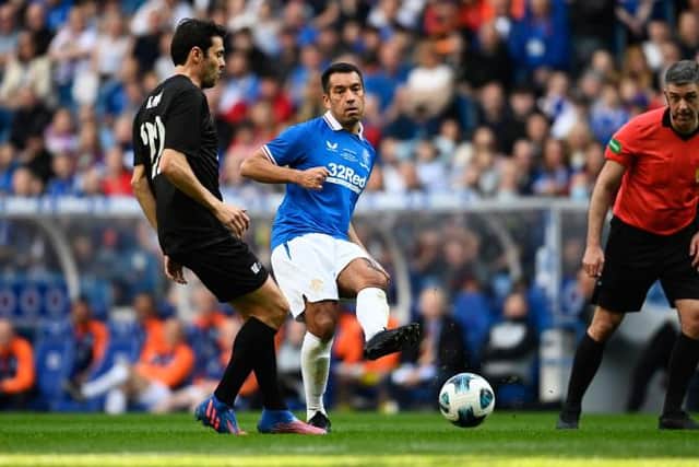 Rangers manager Giovanni van Bronckhorst threads a pass beyond Brazilian star Kaka during the 150th anniversary match at Ibrox. (Photo by Rob Casey / SNS Group)