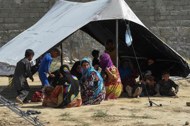 Afghan refugees sit around a makeshift tent shelter on the outskirts of Quetta Pic: Banaras Khan/AFP via Getty Images