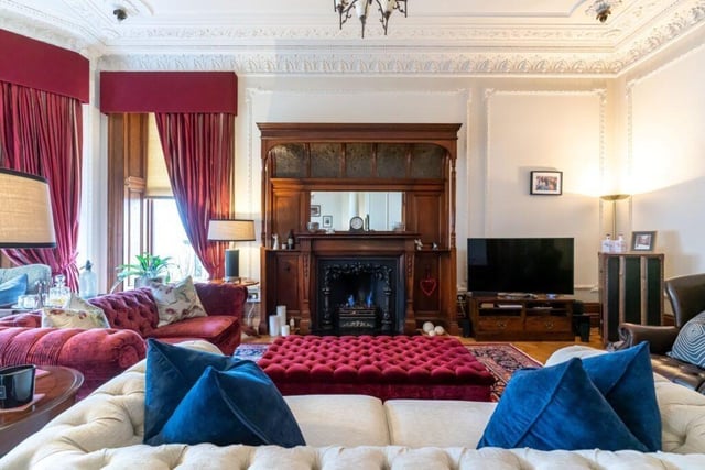 The drawing room has a feature gas fireplace and the original parquet flooring.